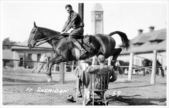 Soldiers performing equestrian stunts, Fort Sheridan, Illinois, USA, 1920. Artist: Unknown