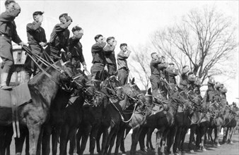 Soldiers saluting while standing on horseback, Fort Sheridan, Illinois, USA, 1920. Artist: Unknown