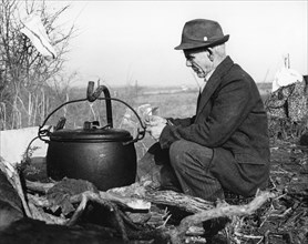 Gypsy man with cauldron, 1960s.