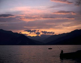Fisherman at sunset, Lake Maggiore, Italy.