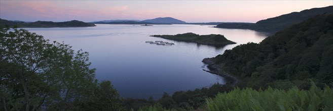 View over Seil Sound to a salmon farm and Luing, Slate Islands, Argyll and Bute, Scotland.