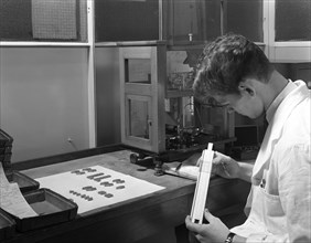 Lab technician with a slide rule, Edgar Allen's steel foundry, Sheffield, South Yorkshire, 1962. Artist: Michael Walters
