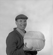 Yorkshireman wearing a flat cap and holding a large ball of twine, 1968. Artist: Michael Walters