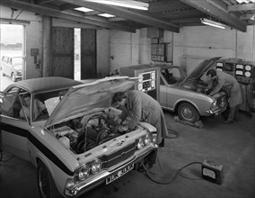 Cortina Mk 2 and Mk3 GT in a garage being serviced/modified, 1972. Artist: Michael Walters