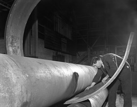 Checking the curve of a steel plate, Edgar Allen's steel foundry, Sheffield, Yorkshire, 1964.  Artist: Michael Walters