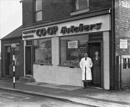 End of rationing, meat and bacon on sale at the Barnsley Co-op butchers, South Yorkshire, 1954. Artist: Michael Walters
