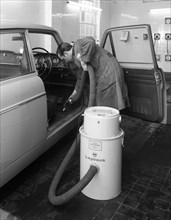 Laycock Vacacar vacuum cleaner in use at an Esso garage, Sheffield, South Yorkshire, 1965. Artist: Michael Walters
