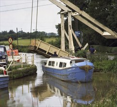 A canal boat passing under a lift bridge on the Llangollen Canal, 1970. Artist: Michael Walters