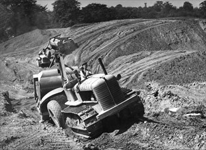 Tractor unit pulling an earth grading machine at a site near Rotherham, South Yorkshire, 1954. Artist: Michael Walters