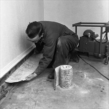 Installing a damp proof course in a house in Goldthorpe, South Yorkshire, 1957.  Artist: Michael Walters