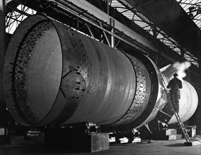 A rotary kiln section being welded in preparation for installation, Steetley, Nottinghamshire, 1962. Artist: Michael Walters