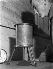 A lab technician undertaking a coal flow test, Mapperley Colliery, Derbyshire, 1962.  Artist: Michael Walters