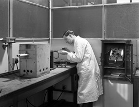 Lab tachnician using a table top test furnace, Sheffield, South Yorkshire, 1962. Artist: Michael Walters