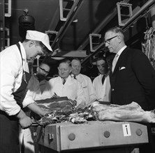 Apprentice butcher showing his work to competition judges, Barnsley, South Yorkshire, 1963. Artist: Michael Walters