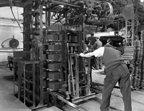 Loading a palletising machine with bricks, Whitwick Brickworks, Coalville, Leicestershire, 1963. Artist: Michael Walters