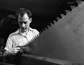 Setting the saw teeth a two metre saw blade, Sheffield, South Yorkshire, 1963. Artist: Michael Walters