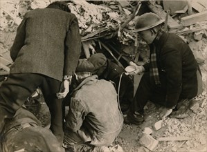 Family buried in a Morrison shelter after a raid, London, 1944. Artist: Unknown