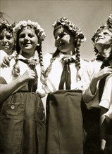 Four German girls smiling with garlands in their hair, c1936. Artist: Unknown