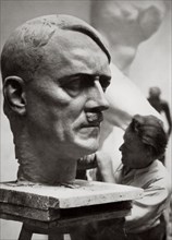 A sculptor working on a large portrait bust of Adolf Hitler, Germany, 1936. Artist: Unknown