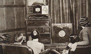People watching an early television transmission, c1920s. Creator: Unknown.