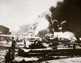 The wreckage-strewn Naval Air Station, Pearl Harbour, 7th December 1941. Artist: Unknown