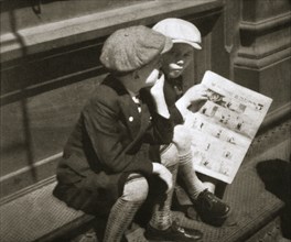 Two boys reading the comic section of the Sunday paper, New York, USA, 1931. Artist: Unknown