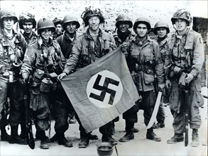 American parachute troops with a captured Nazi flag, Normandy, World War II, 6 June 1944. Artist: Unknown