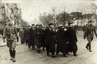 Polish Jews being escorted by German soldiers and Gestapo, Poland, March 1940. Artist: Unknown