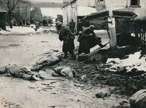 German troops stripping the equipment of dead American troops, Belgium. Artist: Unknown