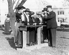 Police officer teaching women how to shoot, c. 1920.