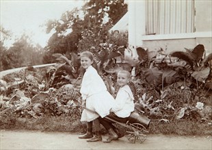 Two children playing outdoors, 1890s. Artist: Unknown