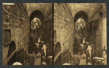 Via Dolorosa, Jerusalem. Pilgrims at station of the Cross (Stereograph), 1913.