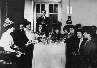 Rasputin (second from left) at the meal among His Admirers, c. 1910.