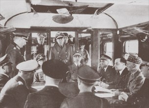The German and French delegations inside a railroad car at Compiègne for the signing of France's sur Artist: Anonymous