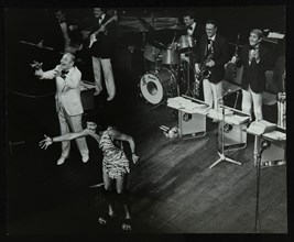 Joe Loss (left) on stage with his orchestra at the Forum Theatre, Hatfield, Hertfordshire, 1986. Artist: Denis Williams