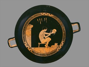 Attic red-figure cup depiting a seated helmet maker and his equipment, c480 BC. Artist: Antiphon Painter.