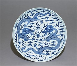 Blue-and-white dish, dragons chasing a flaming pearl, Qing Dynasty, Guangxu Period (1875 - 1908)) Artist: Unknown.