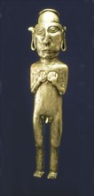 Empty anthropomorphic figure made of silver representing a male person with his arms across his c?