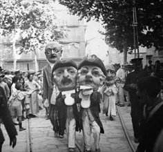 Caparrots and big heads parade through the streets of the city, during the Festivities of Palma d?