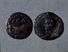 At left a coin with the legend 'Scipione er Montano II vir CCA', at right the front with the word?