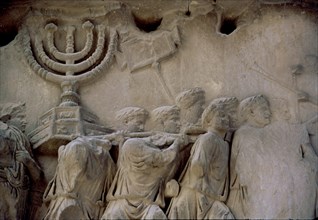 Basrelief in the Arch of Titus representing men carrying a menorah, located in the Via Sacra of t?