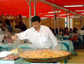 Mediterranean cuisine, chef preparing a paella, Feria de Abril (April Fair) 2002.