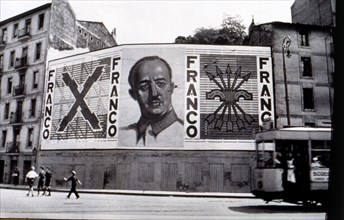 Spanish Civil War (1936 - 1939), nationalist painting with the face of Franco and symbols of the Falange in a building in Bilbao