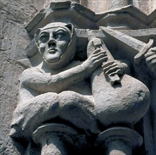 Detail of a capital representing a bagpiper, in the cloister of the Monastery of Santes Creus, ma?