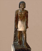 Hieratic statue of a man, made in polychromed limestone.