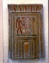 Door shaped stela representing Senouret and his wife in front of their offerings, made in polychr?