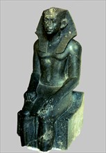 Seated statue of Sesostris III depicted as a young man, made in diorite, comes from Medamout, 187?