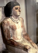 Statue of a seated man, in polychromed limestone.