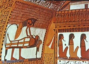 God Anubis mummifying a deceased, fresco in the tomb of Sennutem.