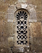 Window in the apse with a Visigothic lattice, in the church of San Juan de Baños.
